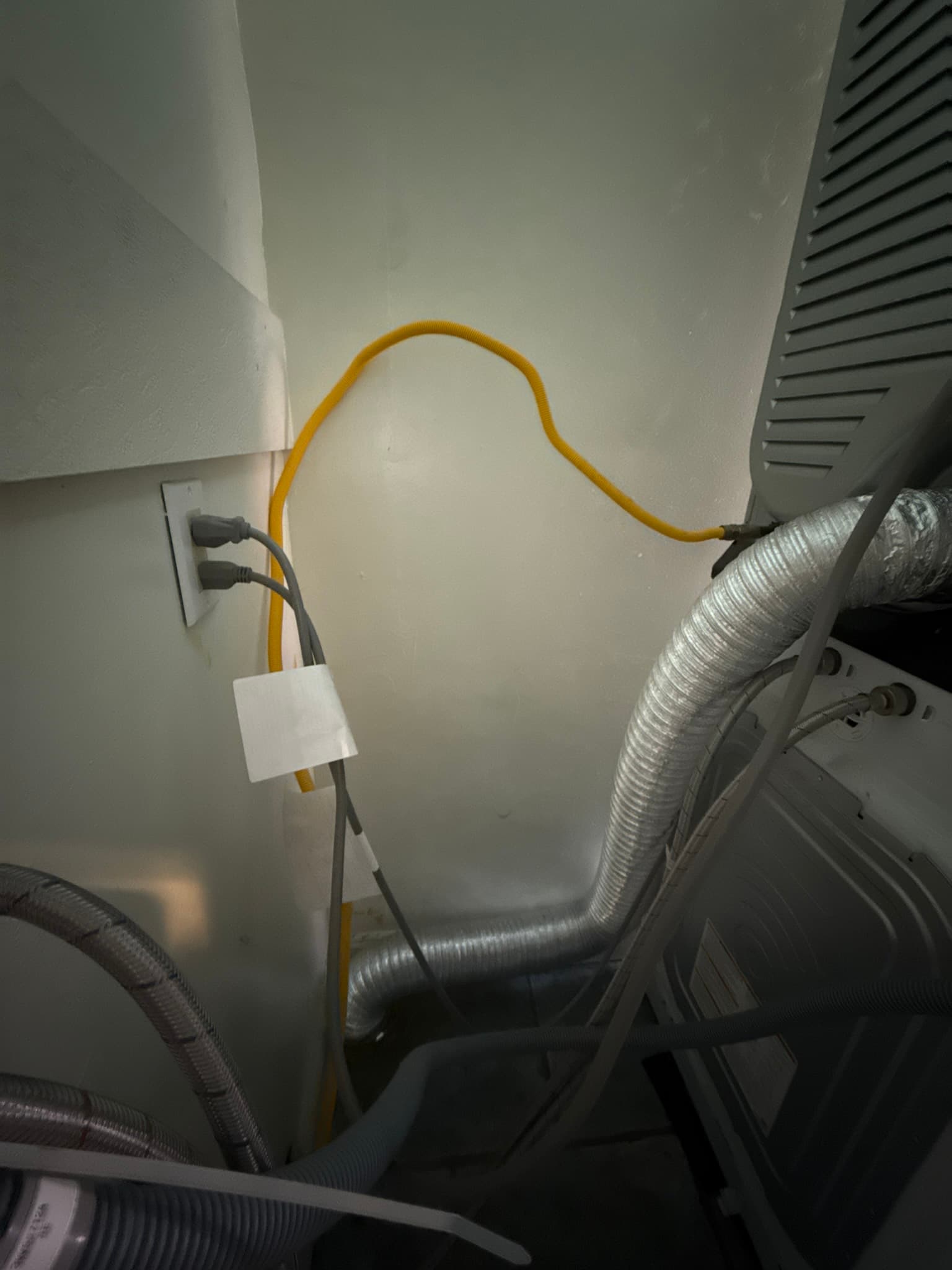 UL 2158A fire-rated flexible transition duct connecting the dryer exhaust outlet to the rigid duct system, with product labeling visible on the silver foil connector