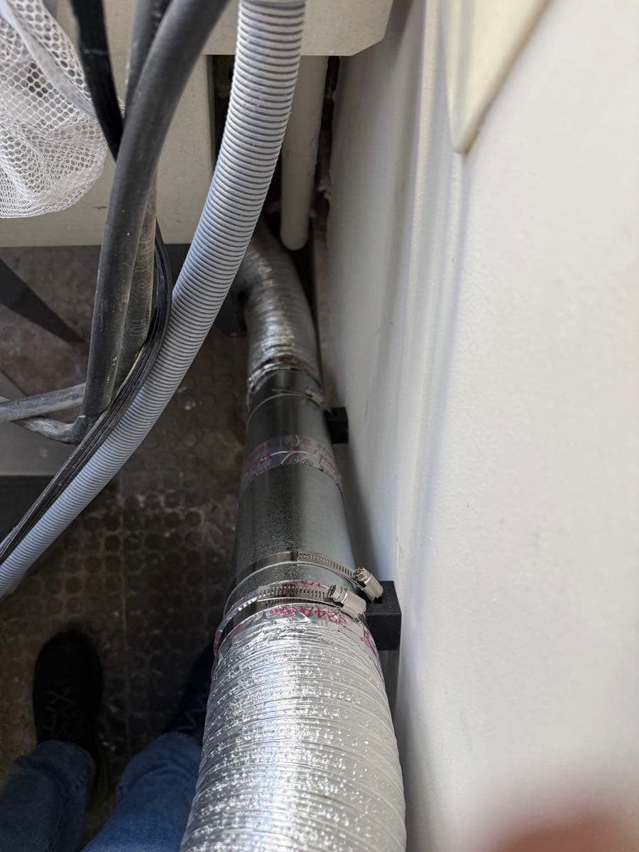 After photo showing completed fire-rated metal dryer vent transition duct installation