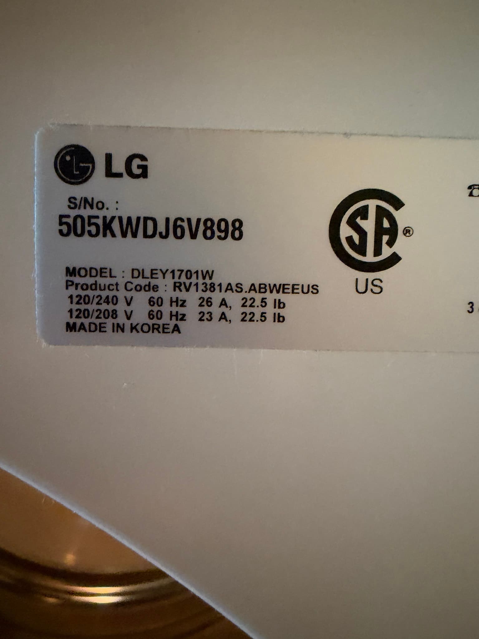 Close-up of an LG dryer's rating label showing the model number, photographed during the inspection documentation.