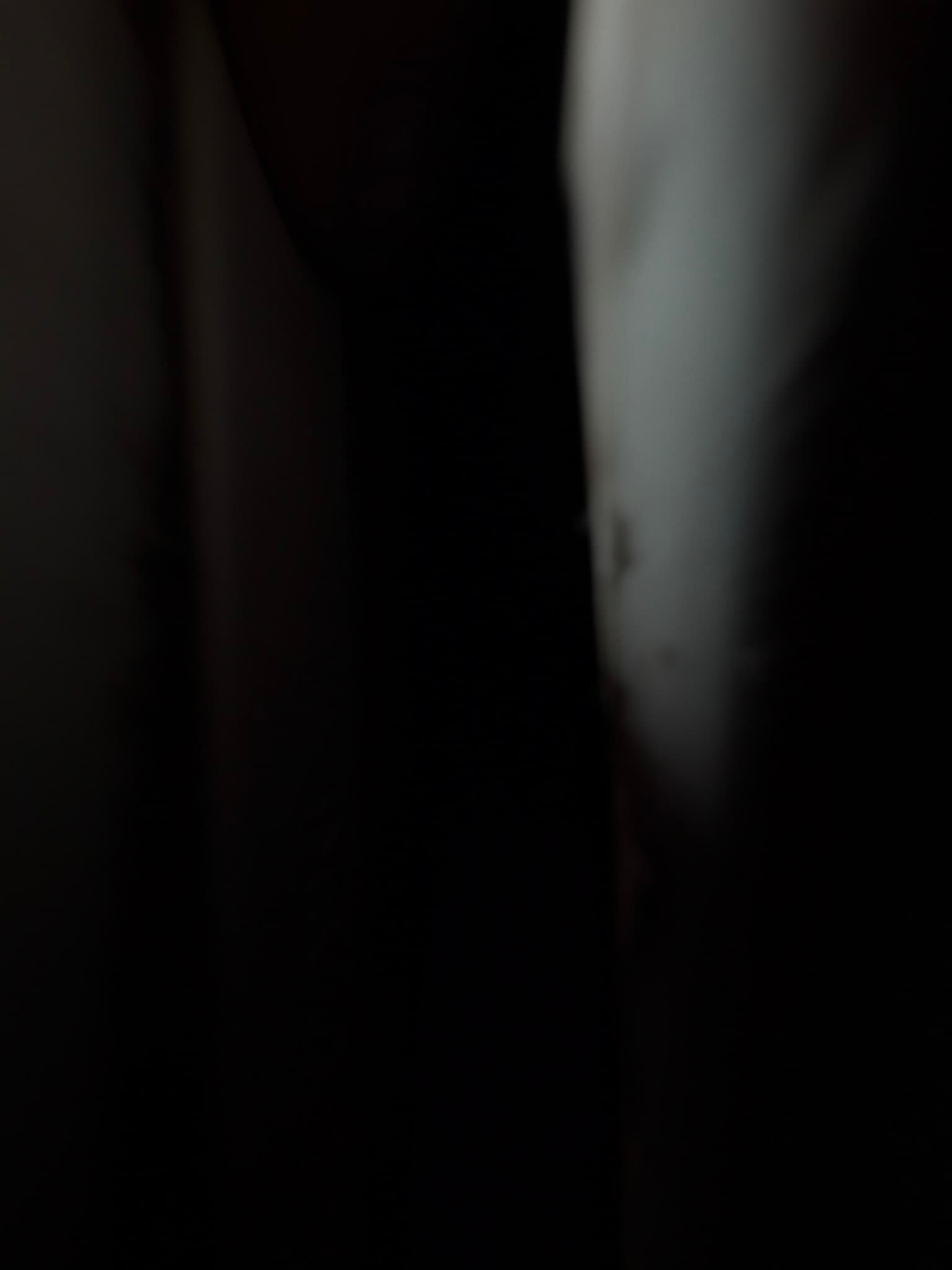 Dark, out-of-focus photo of a metal duct section during the exhaust run inspection