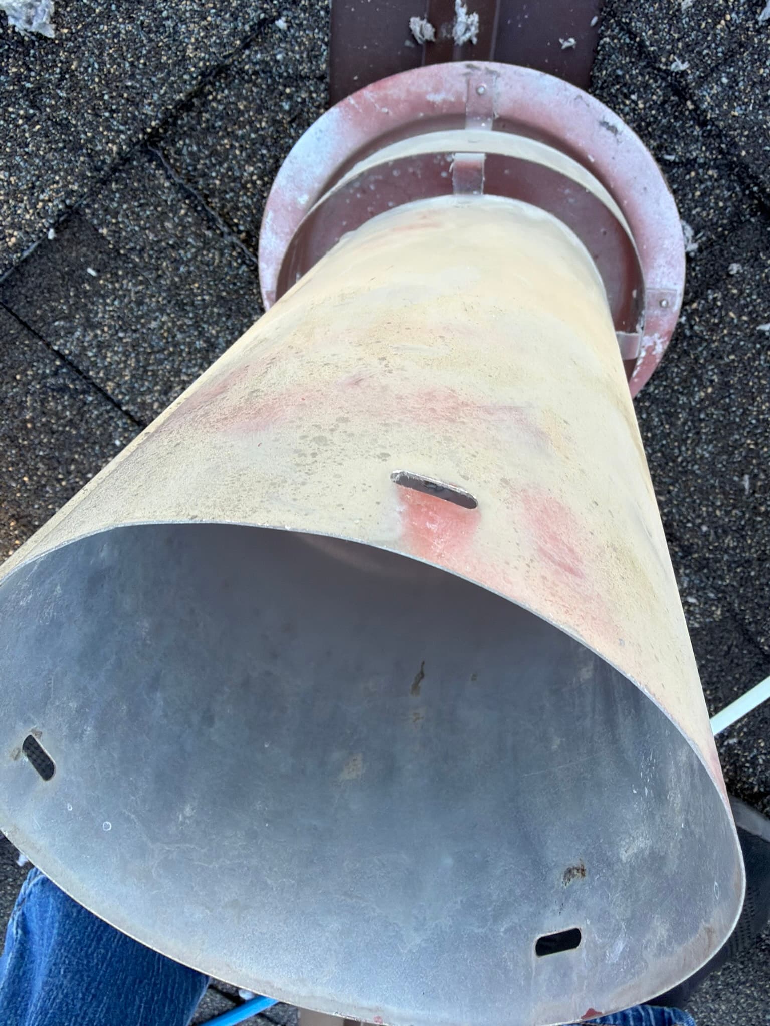Rigid metal roof cap with domed hood and flashing collar on an asphalt shingle roof, properly seated after inspection