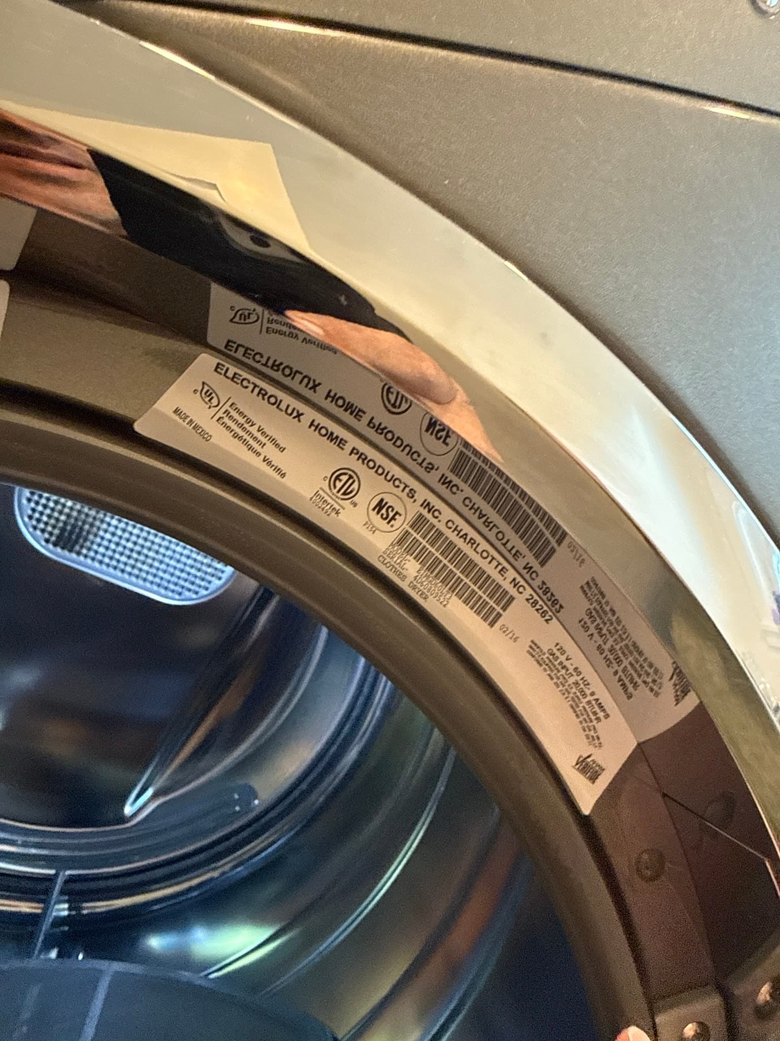 Top rear panel of the home dryer showing the manufacturer label, clean and undamaged