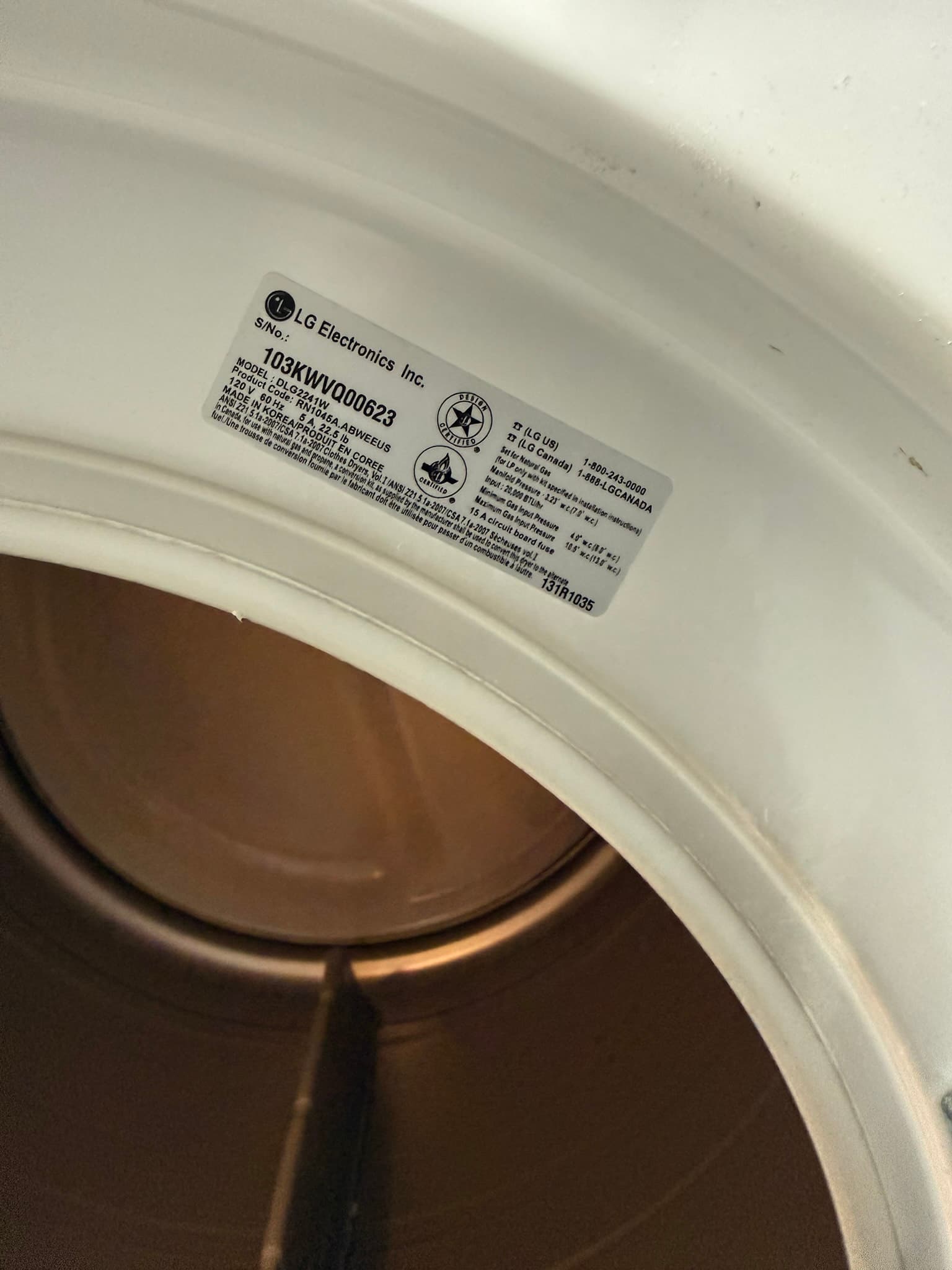 Manufacturer label on an LG Electronics residential dryer showing model number D3KWV000622, affixed to the top of the white unit above a dark interior drum