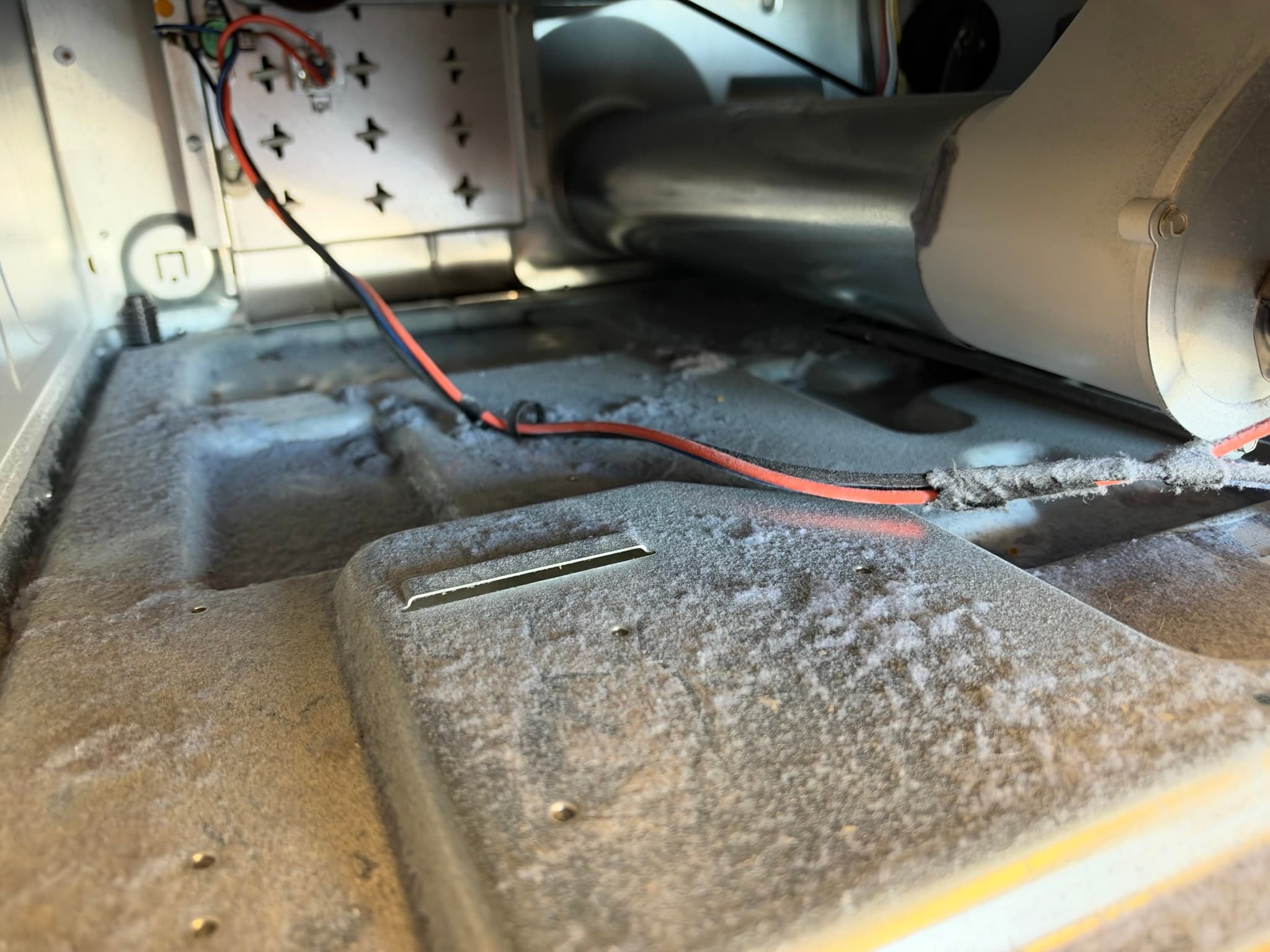 Close-up of lint buildup removed from the interior wall of a dryer exhaust duct