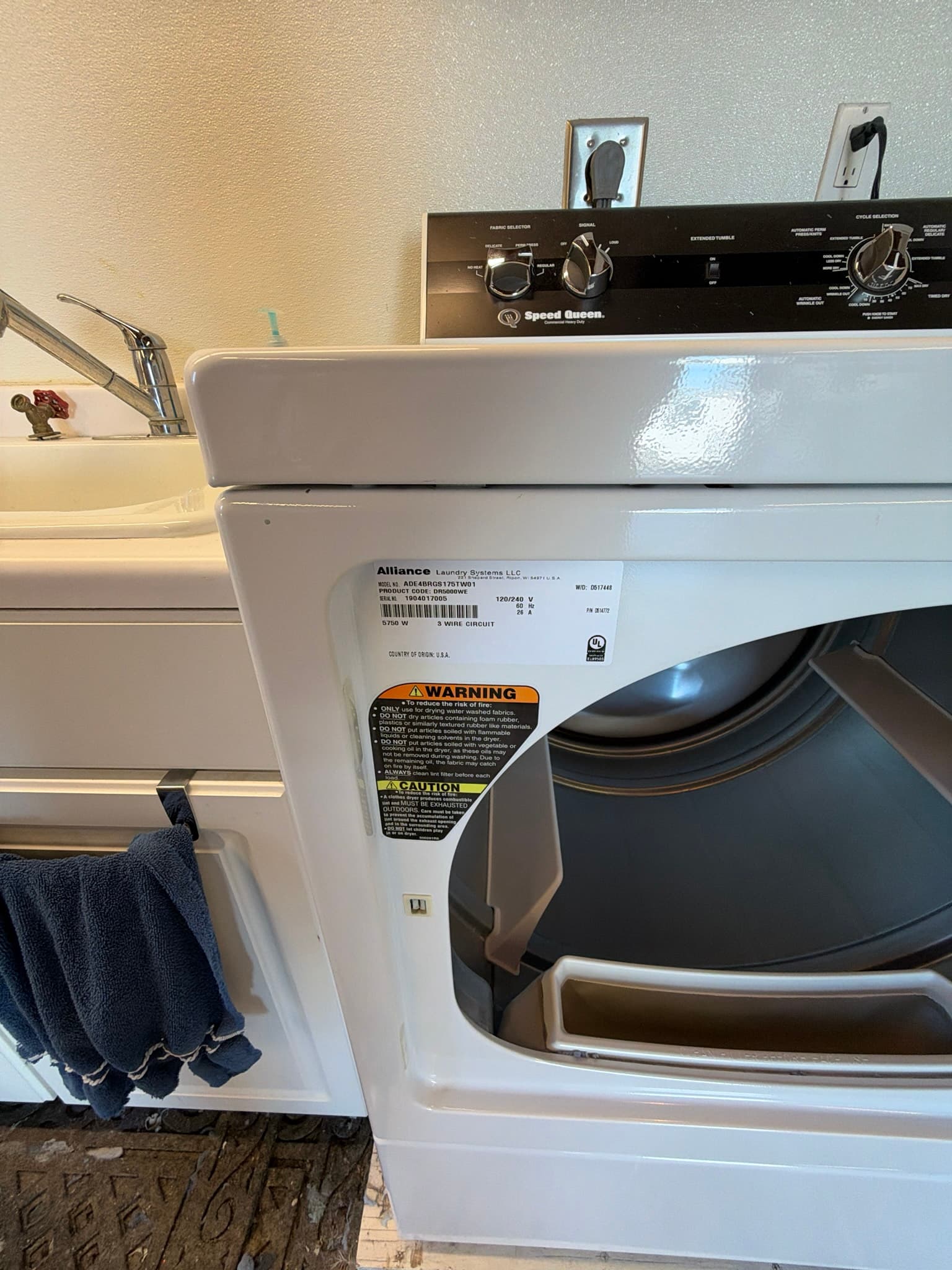 Rotary brush being fed through the transition duct behind the dryer during the cleaning process