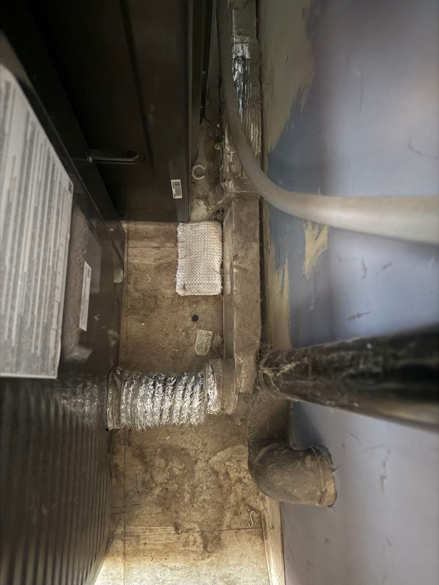 Non-compliant periscope vent completely clogged with lint and improperly taped connections