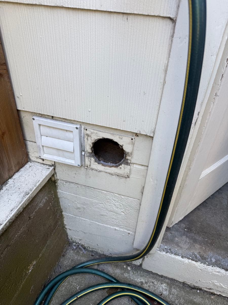 Before photo showing the original dryer vent area prior to new installation work