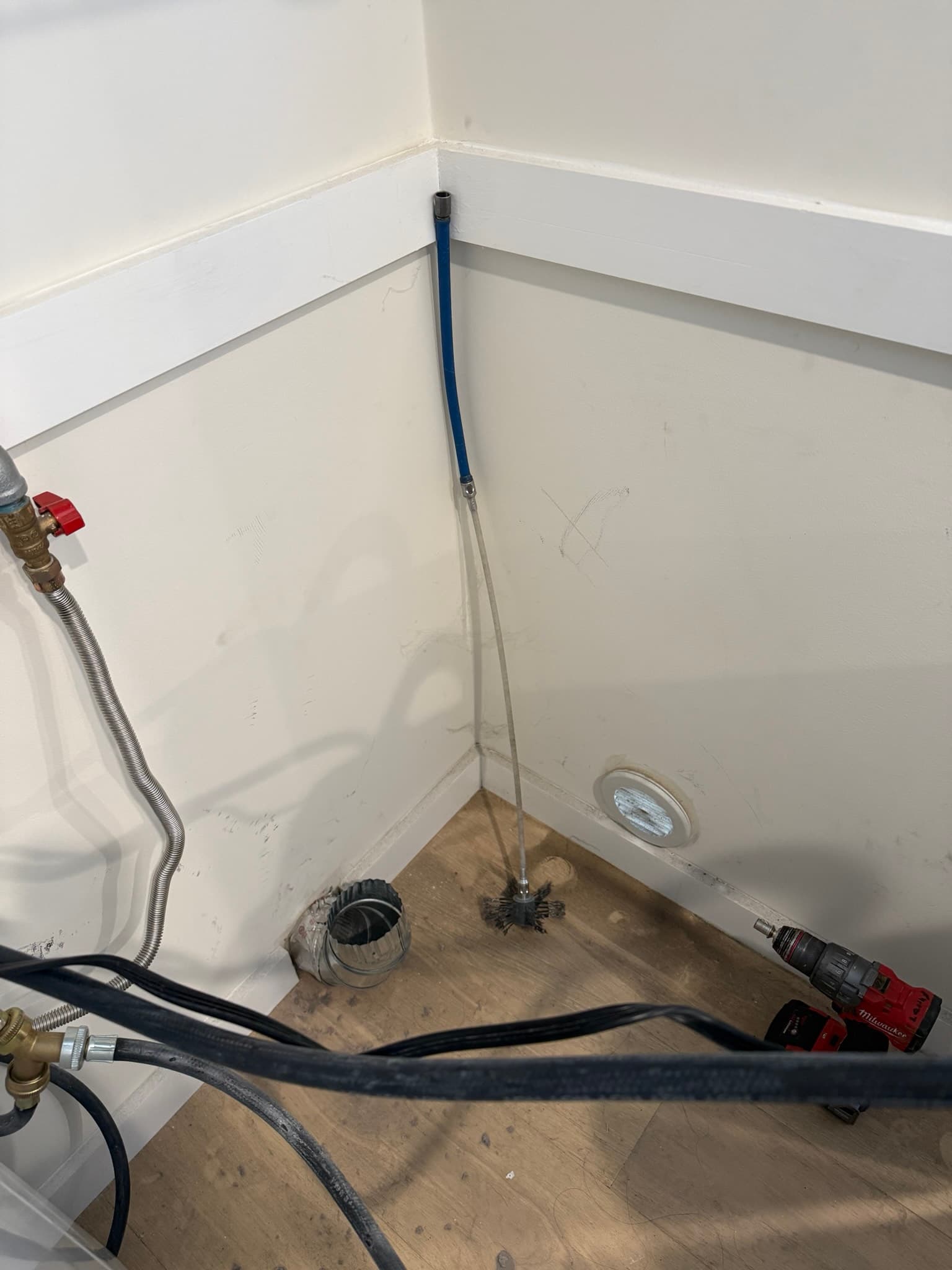 Interior view of dryer ductwork before cleaning showing accumulated lint buildup