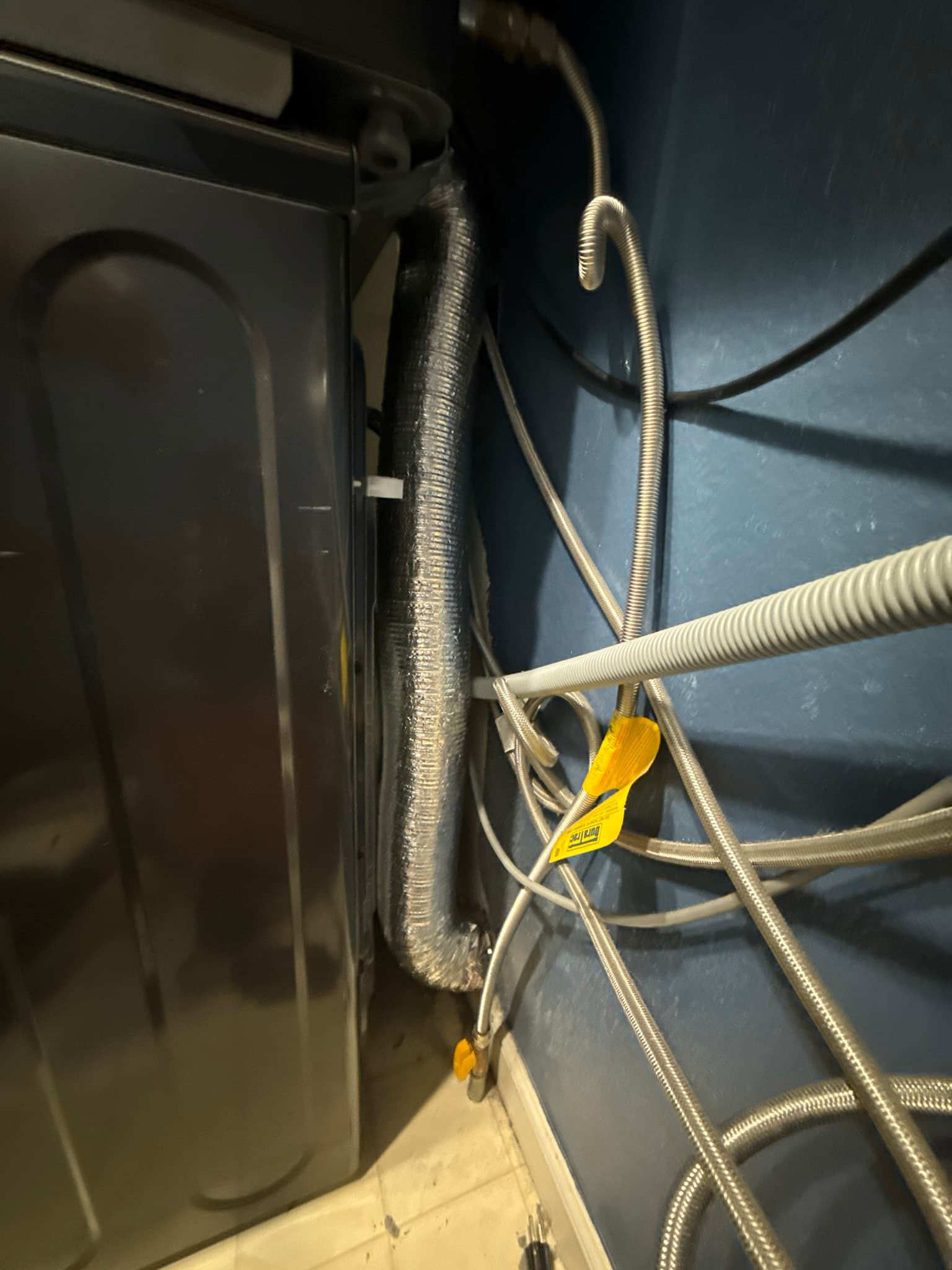 UL 2158A fire-rated flexible transition duct connecting a residential dryer to the rigid wall exhaust duct