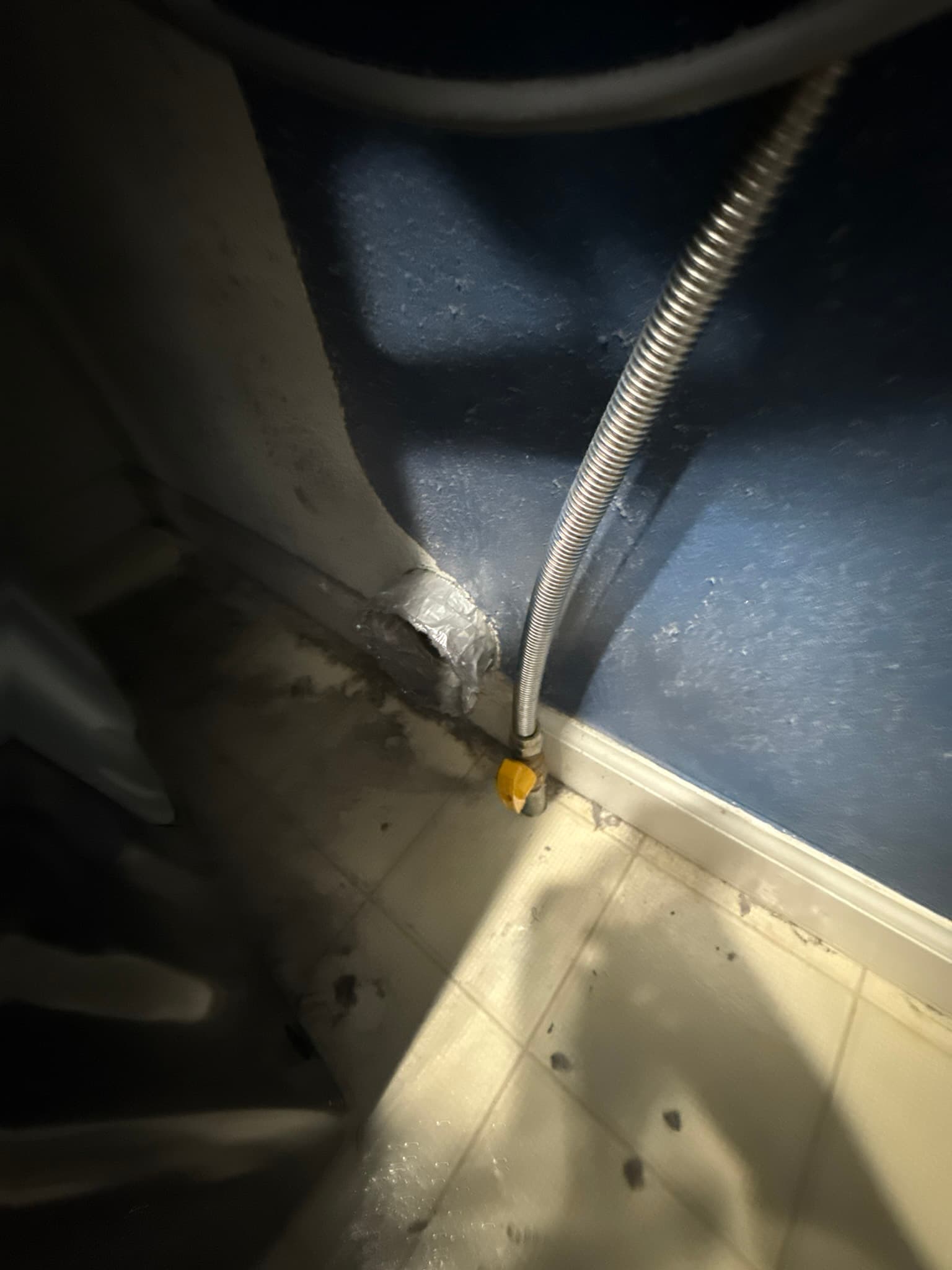 Dryer vent duct or components during the cleaning and inspection process in a residential laundry area