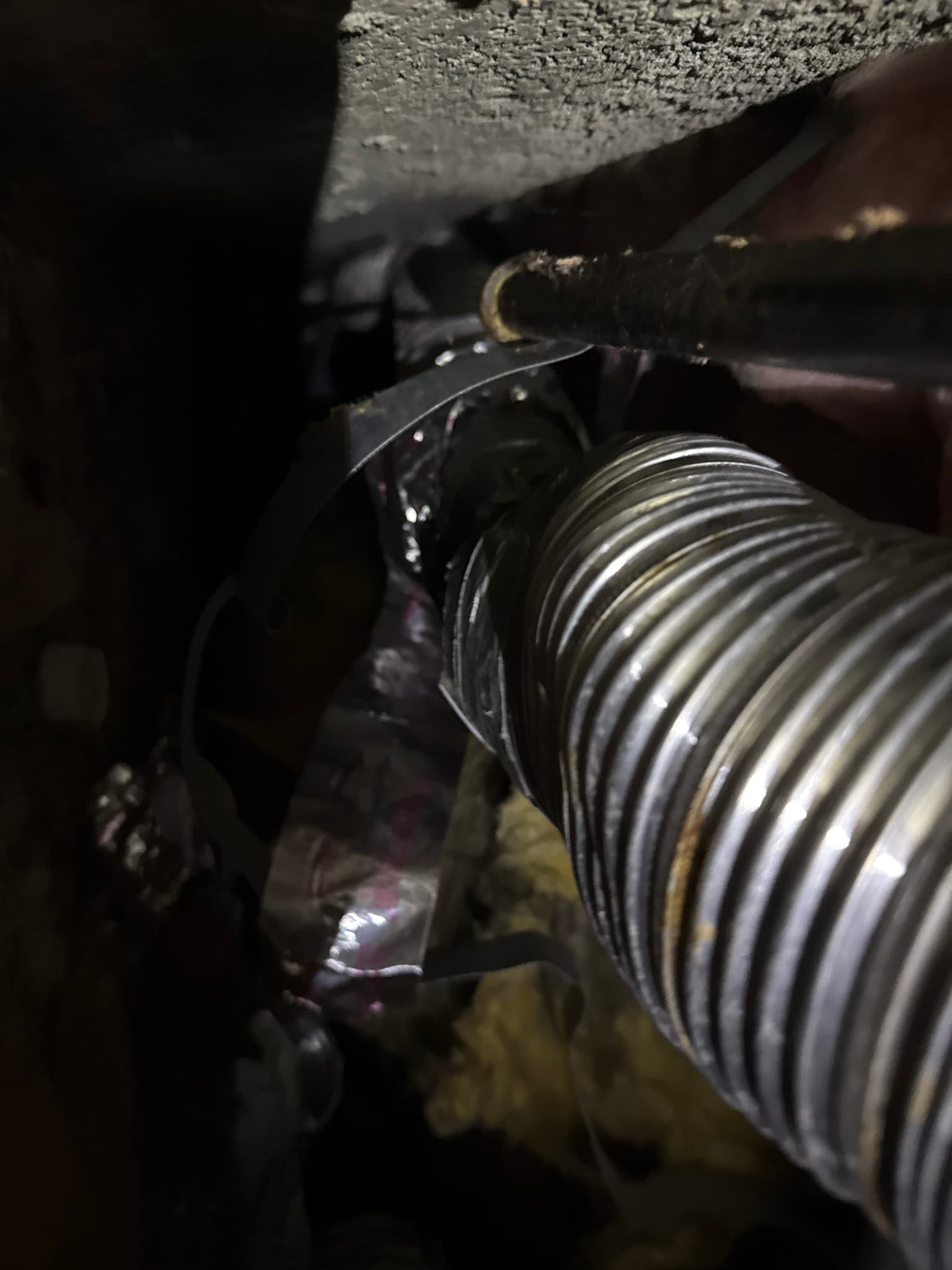 The prohibited 2-inch duct restriction within the 4-inch dryer exhaust duct run, creating a significant airflow choke point