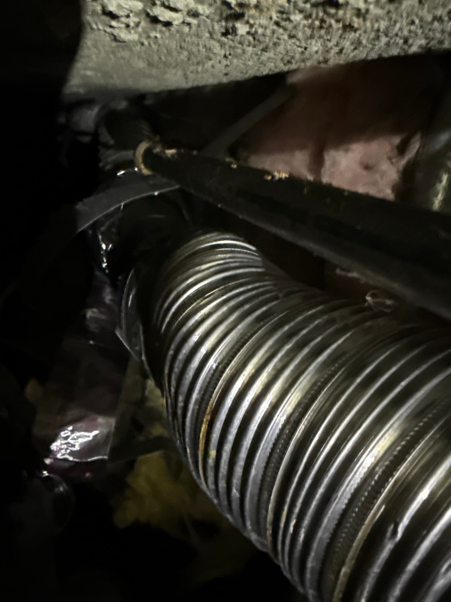 Disconnected dryer duct section inside the wall cavity where exhaust was venting into the building structure