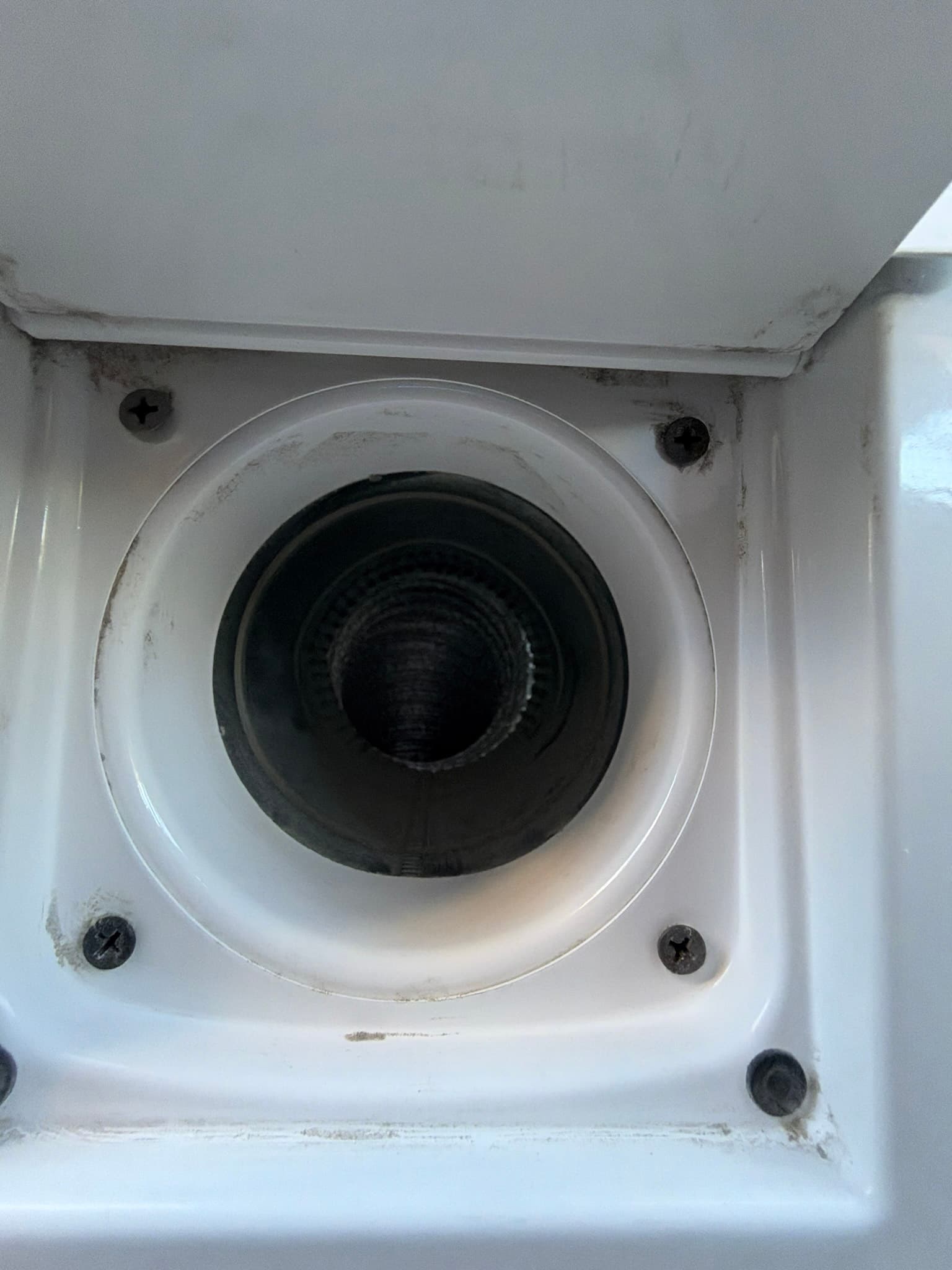 Additional view of the completed dryer exhaust connection in the utility closet after service