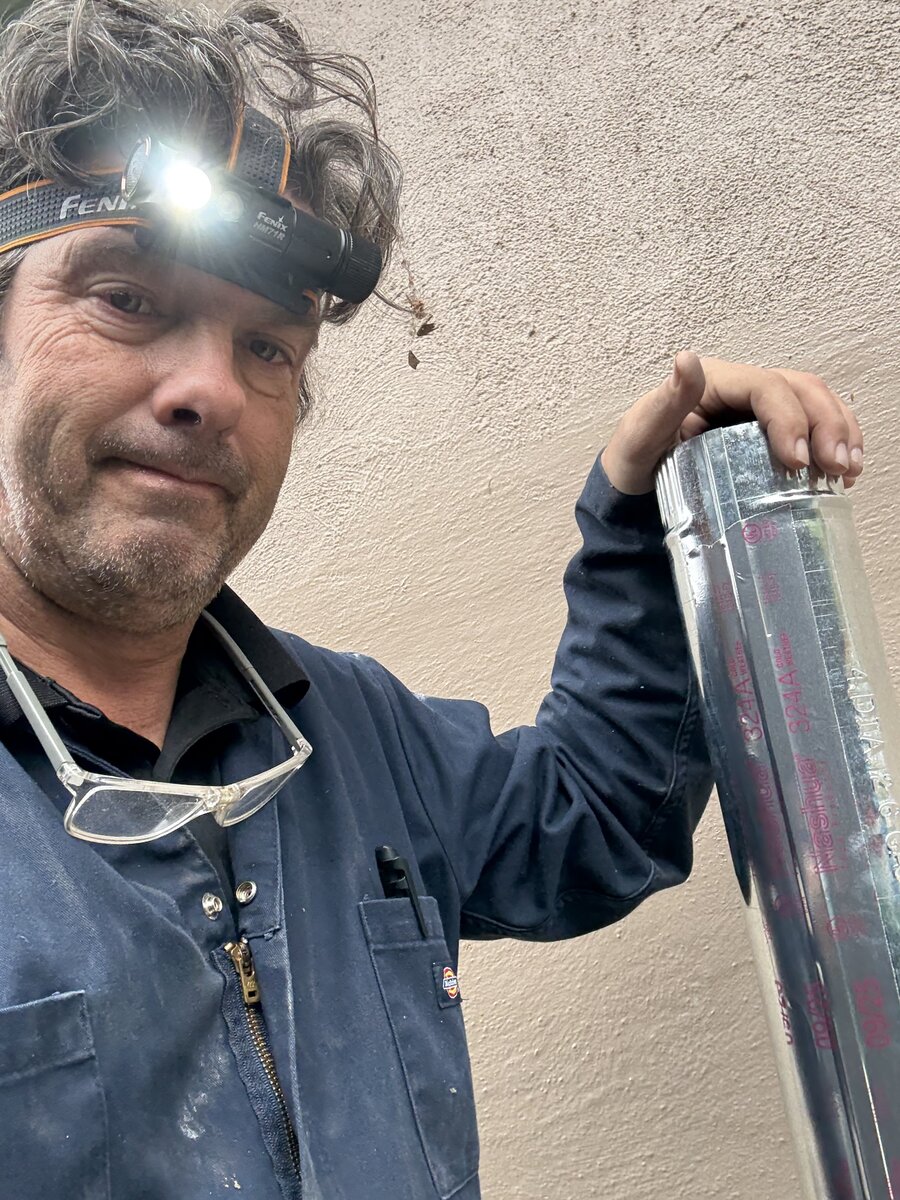 CDET certified dryer vent technician inspecting vent system