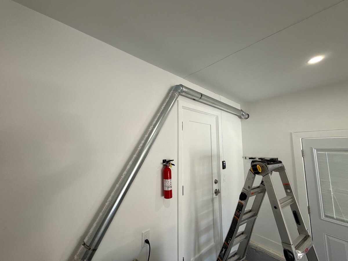 Professional rigid metal dryer vent duct installation in garage
